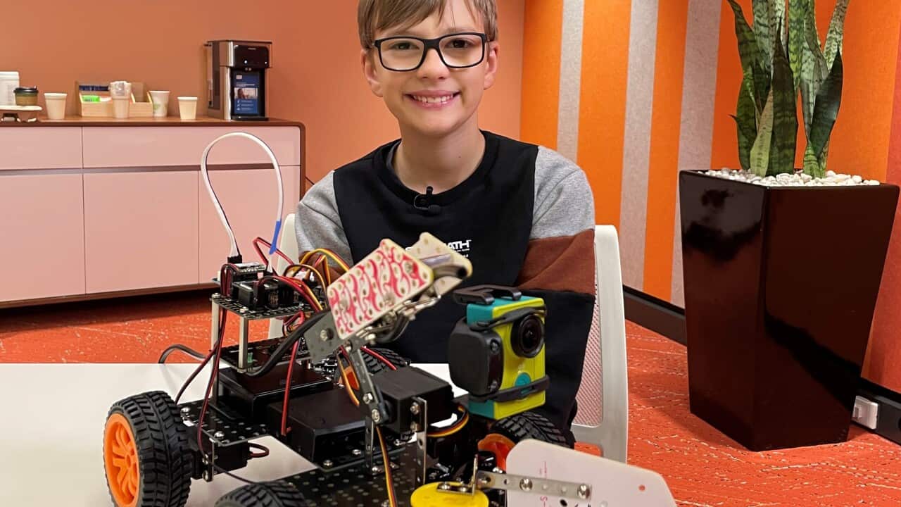 Harrison Ractivand, 12, with his award winning firefighting robot (SBS).jpg