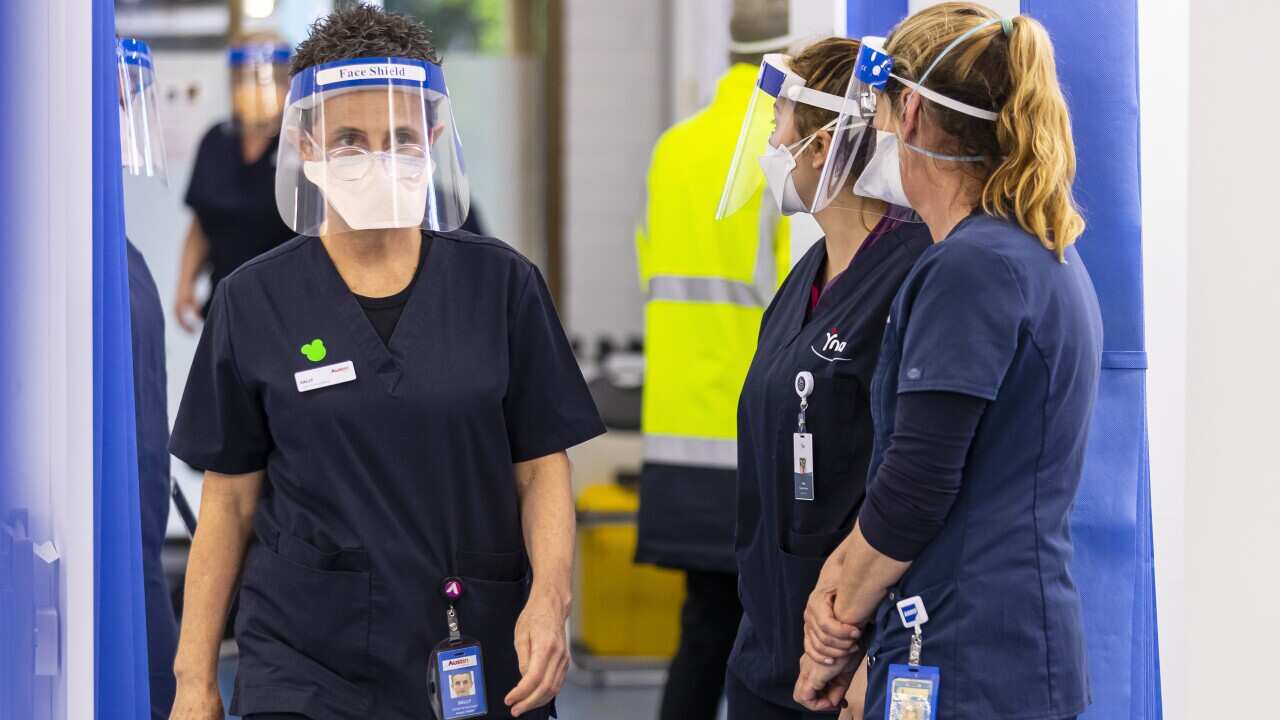Healthcare workers are seen in the COVID vaccination hub at the Heidelberg Repatriation Hospital in Melbourne, 13 September.