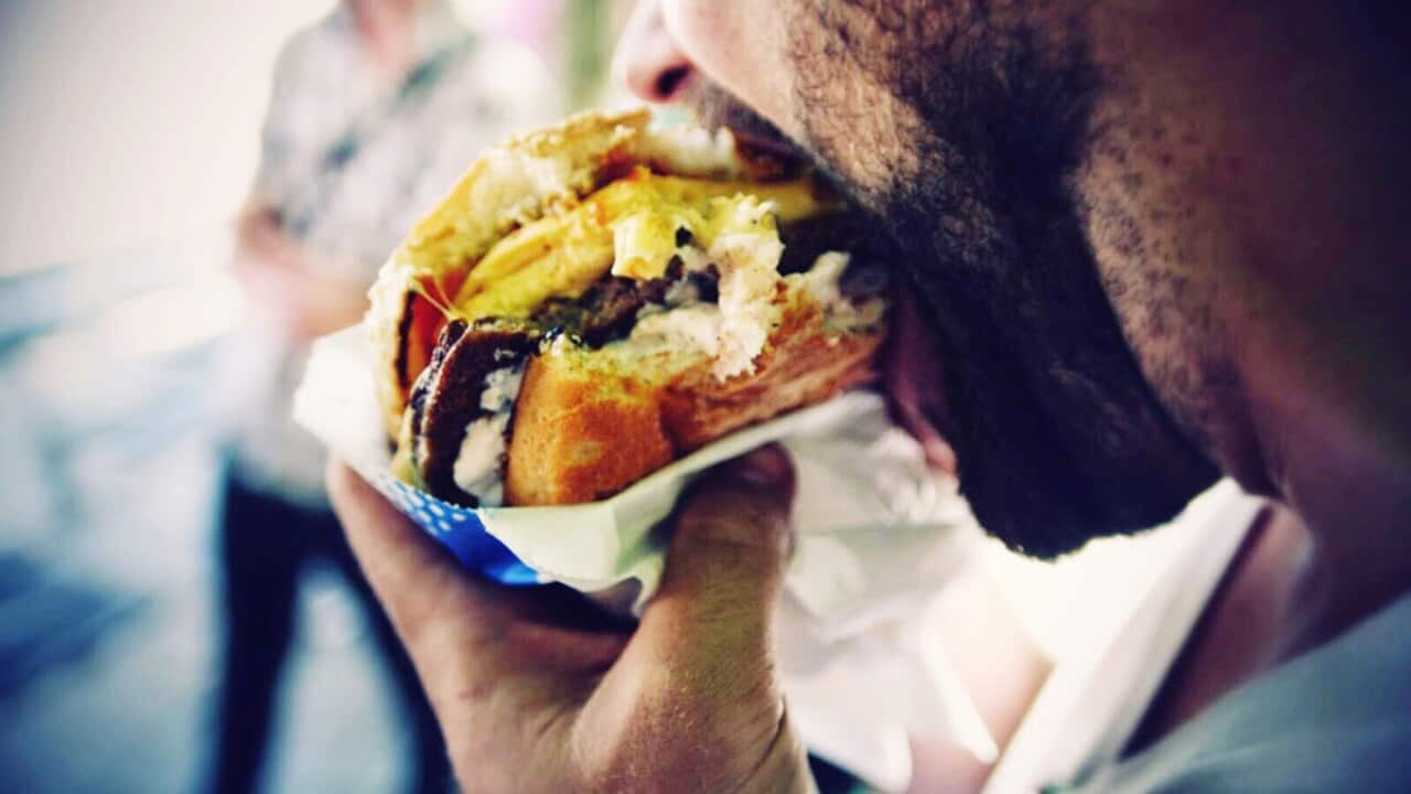 Man eating a takeaway burger