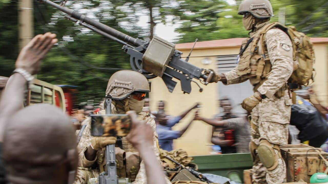 Malian soldiers parade as they arrive by military vehicle at Independence Square in Bamako on 18 August, 2020.
