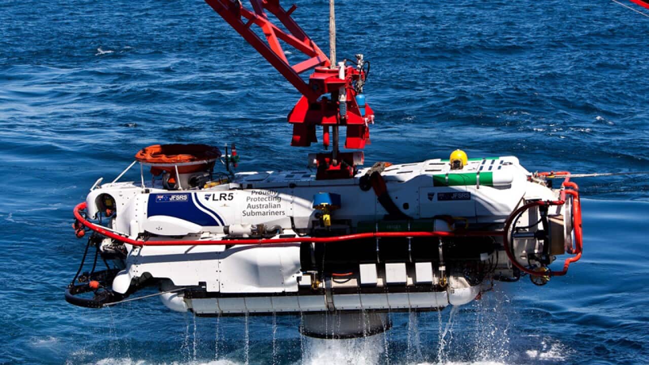 A submersible clears the water after a successful personnel transfer