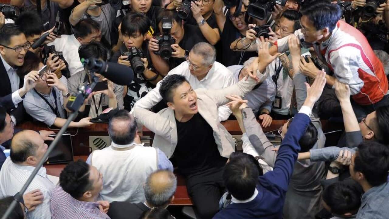 People scuffling in Hong Kong's Legislative Council.