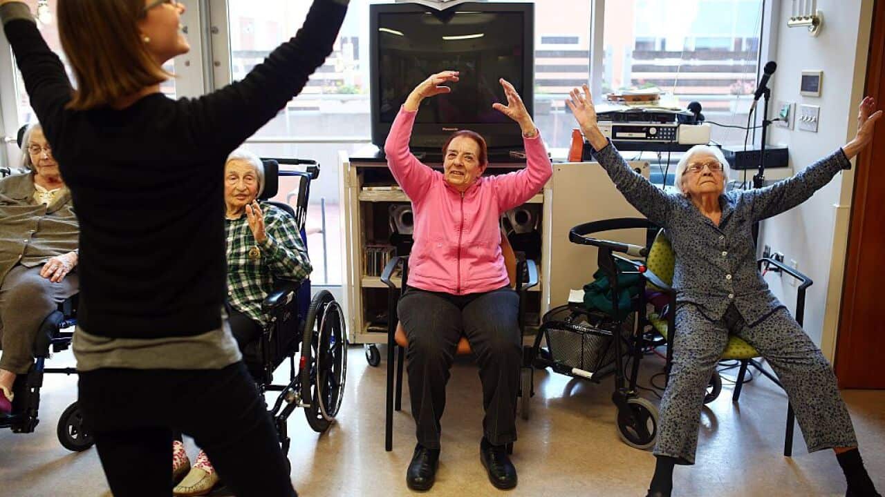 Canadian dementia patients dance along with instructors in an exercise class.
