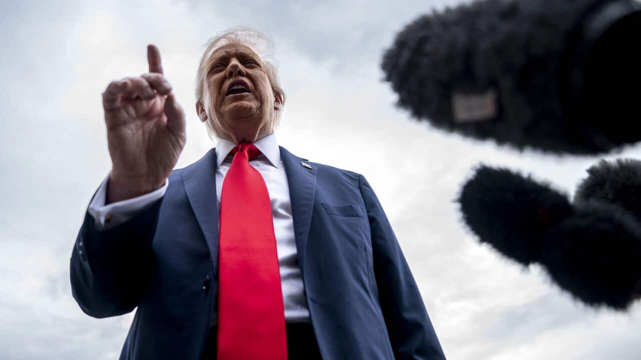President Donald Trump raising a finger at reporters before he departs for the United Kingdom