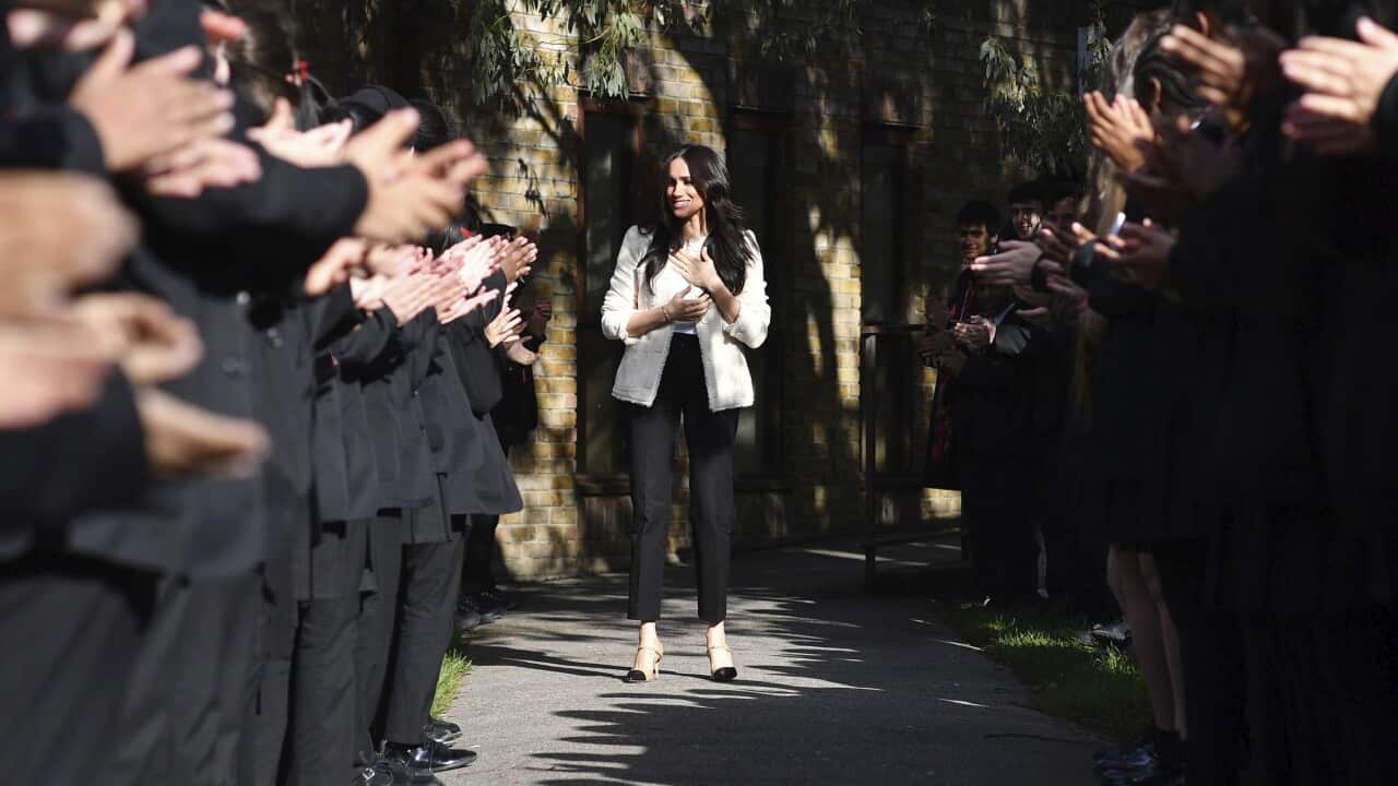 The Duchess of Sussex is greeted by pupils at the Robert Clack Upper School in Dagenham, Essex.
