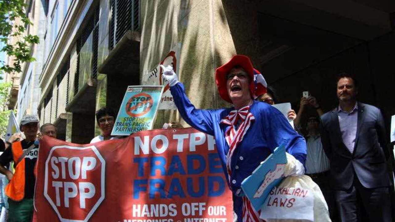 Protesters rally outside Sheraton Hotel in Sydney as global trade ministers meet at the venue to discuss the Trans-Pacific Partnership (TPP) free-trade agreement