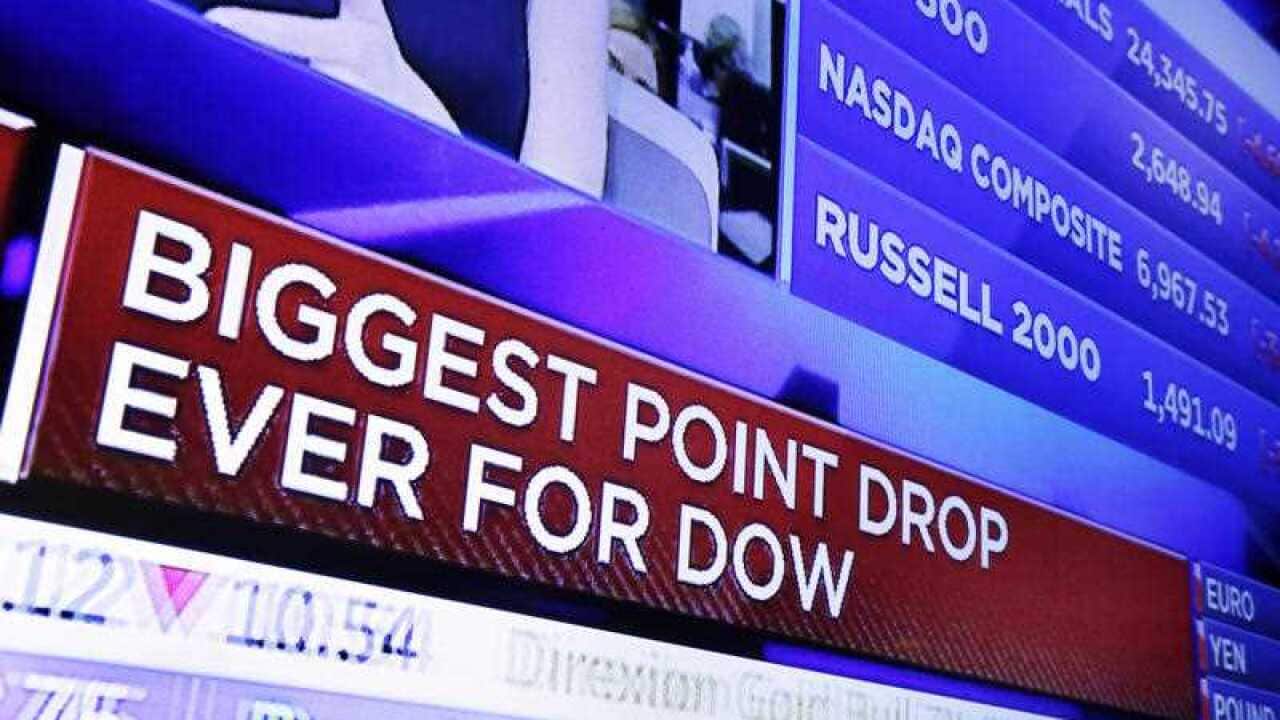 A television screen on the floor of the New York Stock Exchange headlines the stock index news at the close of trading, Monday, February 5, 2018.
