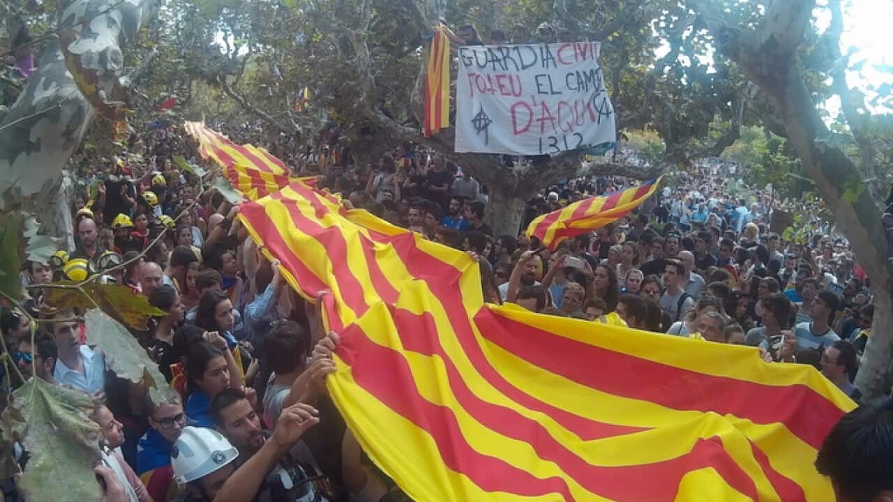 Protesters in Barcelona hold a Catalan flag