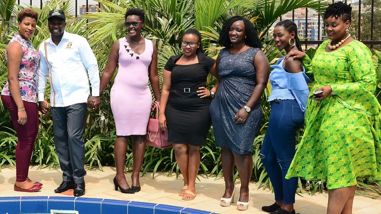 Uganda's minister for Tourism Godfrey Kiwanda poses next to participants during the launch of the Miss Curvy beauty contest this week.