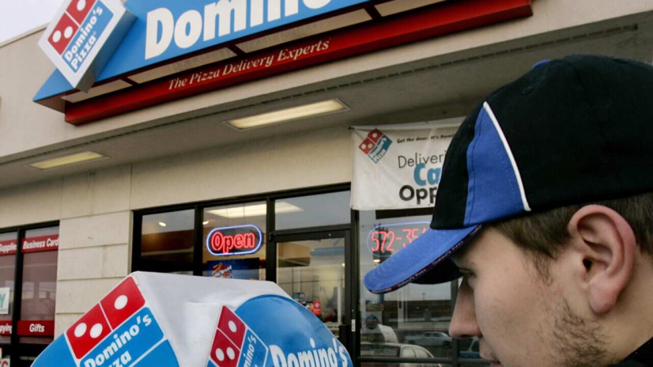 A Domino's Pizza delivery person