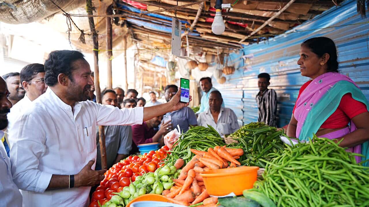 India: G. Kishan Reddy makes a payment through the UPI to a vegetable seller at a roadside market in Jubilee Hills