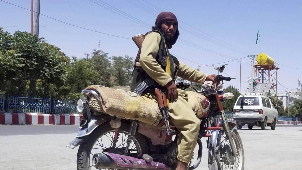 A Taliban fighter poses for a photo inside the city of Ghazni, Afghanistan, Thursday, Aug. 12, 2021.