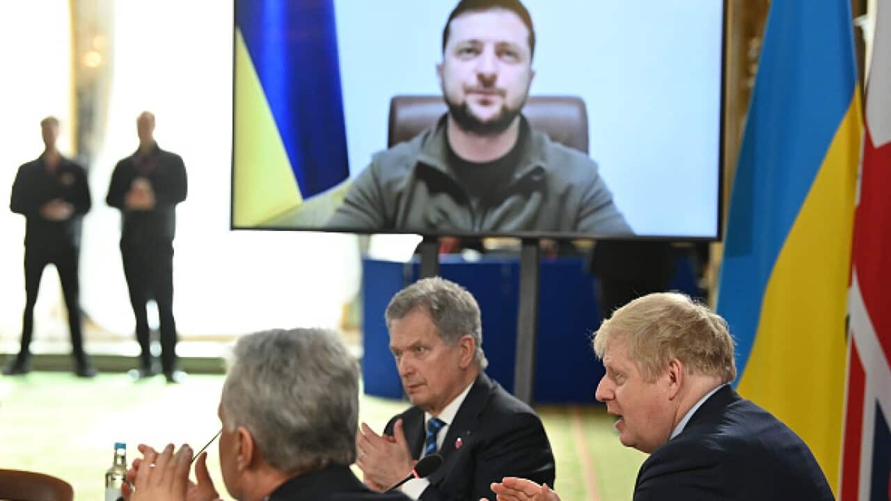 Ukraine president Volodomyr Zelenskyy is pictured on a large screen at a meeting in London of leaders of the Joint Expeditionary Force including Boris Johnson (right).