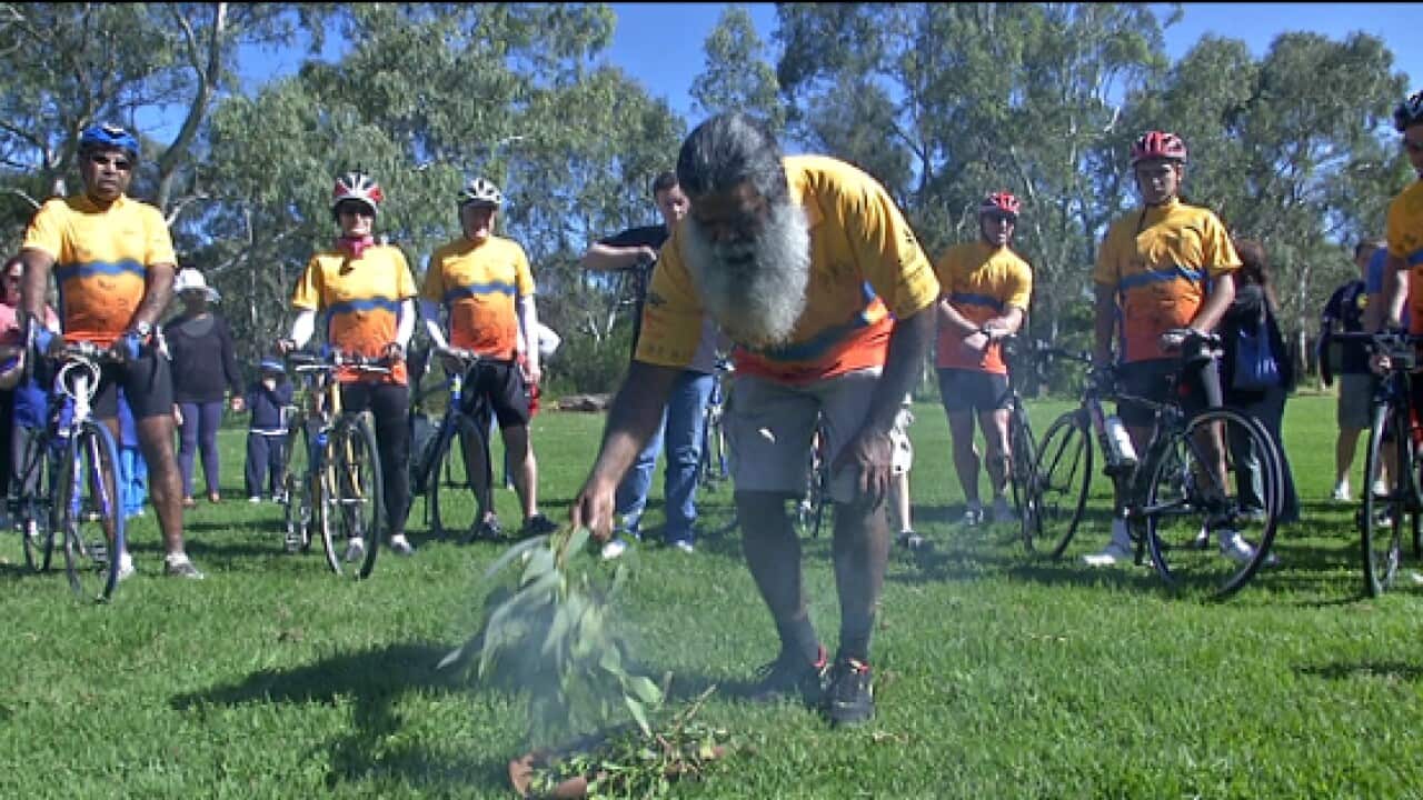 a smoking ceremony sends off riders in the cycling for culture event.jpg