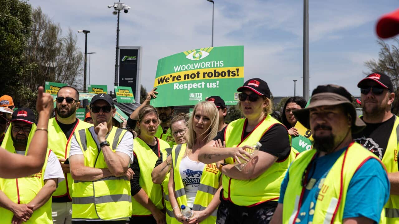 Workers wearing yellow vests participate in a strike.