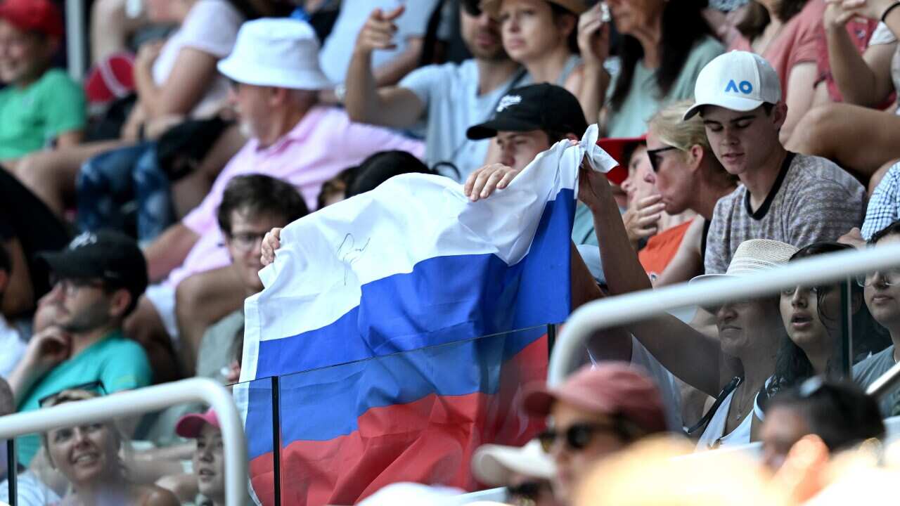 A Russian flag is displayed by spectators at the Australian Tennis Open (AAP)