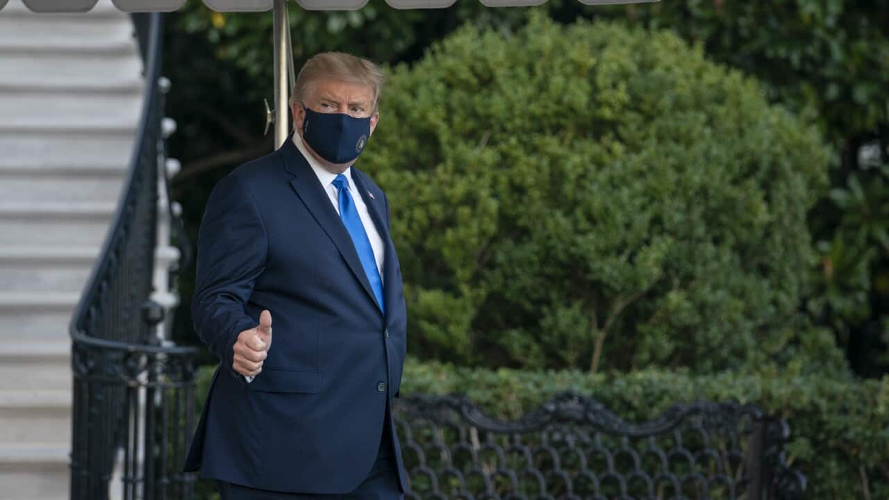 Donald Trump walks along the South Lawn of the White House before boarding Marine One