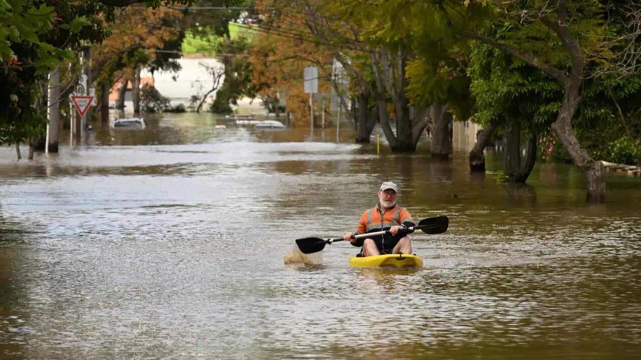 A man is canoeing along flood waters in Maribyrnong, Melbourne.jpg