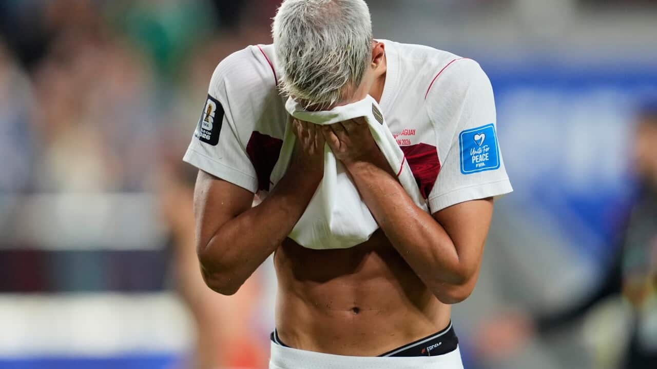 A man burying his face in his t-shirt.