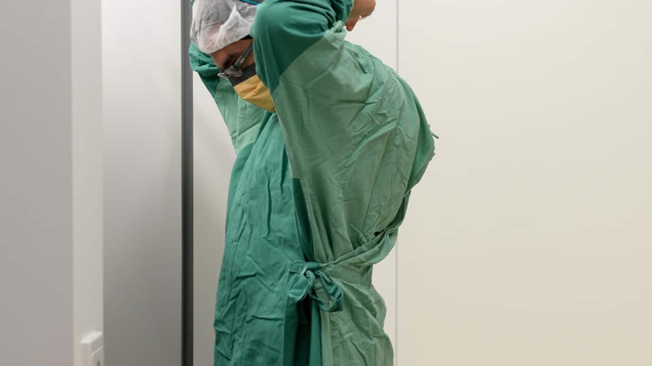 A surgeon prepares for theatre in a hospital