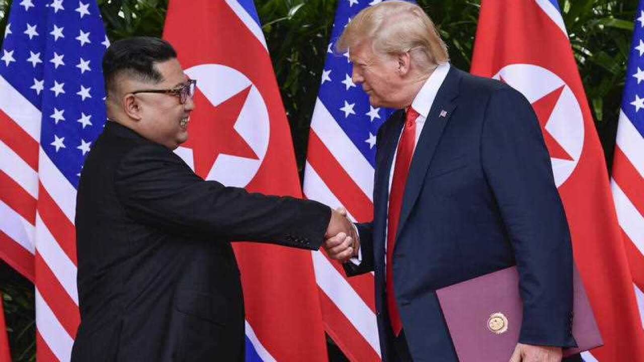 North Korea leader Kim Jong-un and US President Donald Trump shake hands at the Capella resort on Sentosa Island in Singapore.