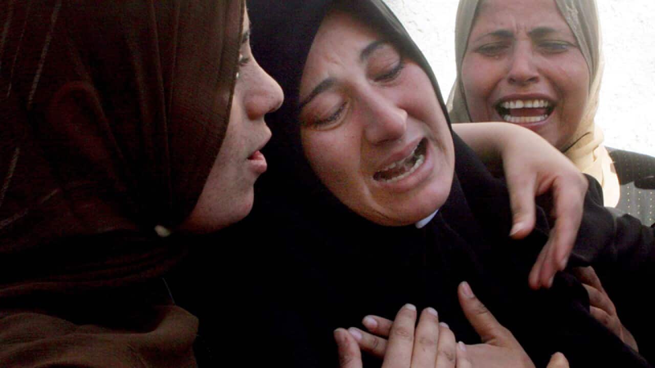 Relatives mourn during the funeral procession in Gaza Strip