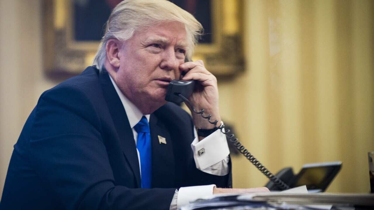 US President Donald Trump speaks on the phone with Prime Minister of Australia, Malcolm Turnbull, in the Oval Office in Washington.