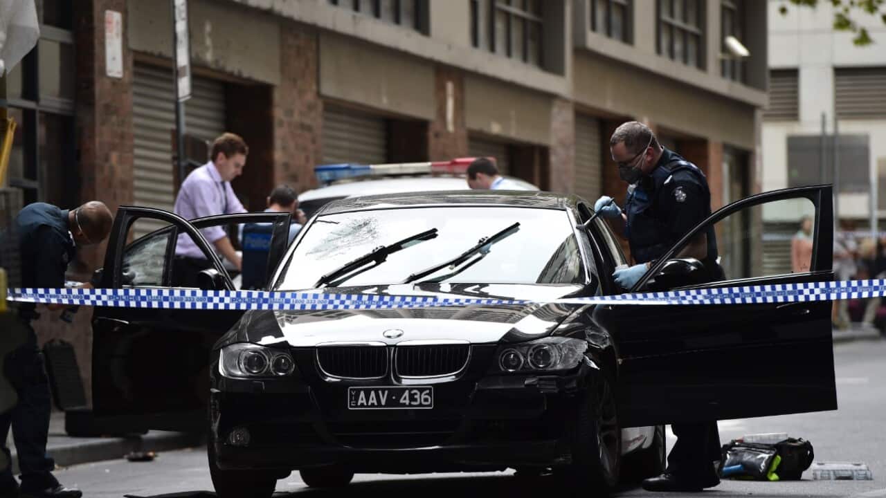 Police investigators dust a black BMW for fingerprints in Downie Street in Melbourne's CBD, Tuesday, March 29, 2016. 