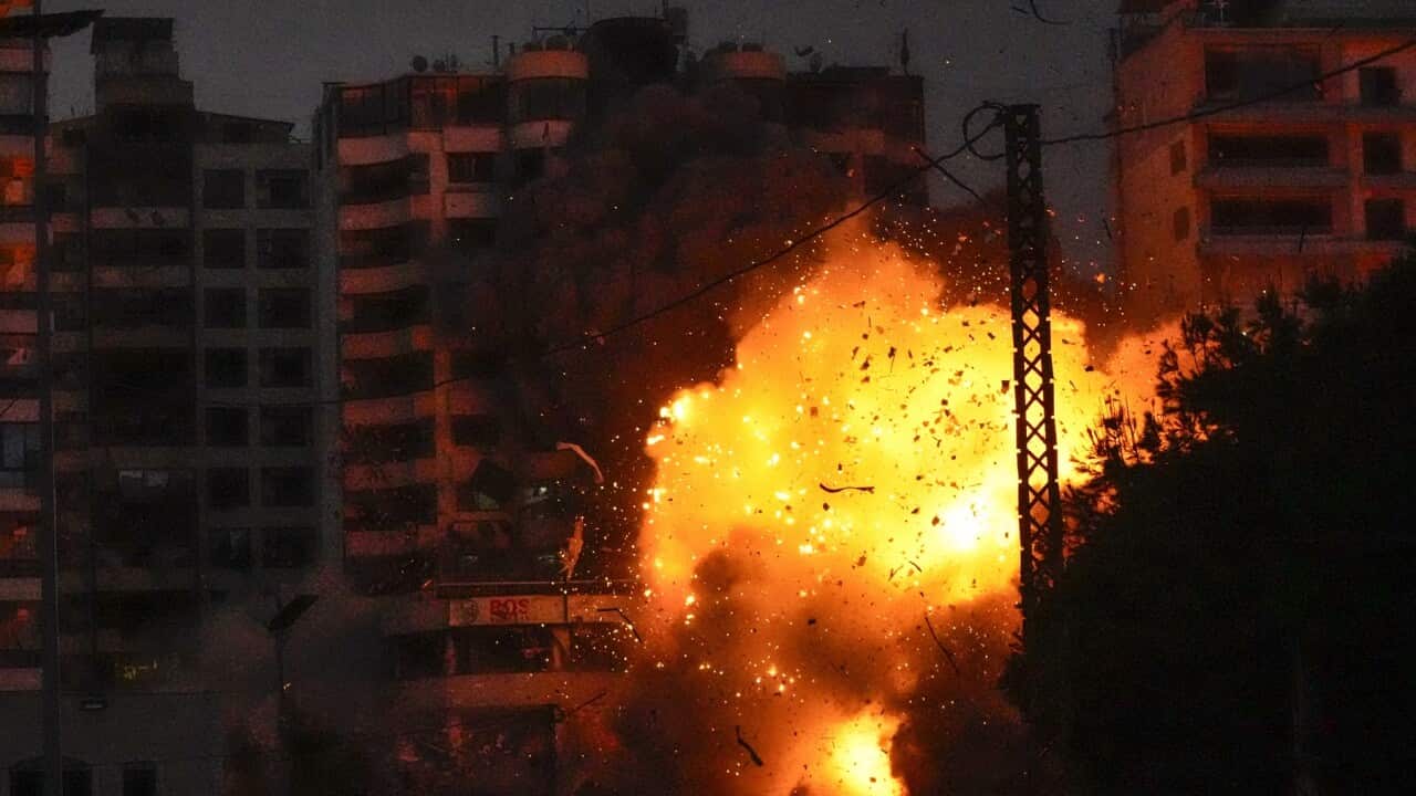 Thick smoke, flames and debris erupt from an Israeli airstrike that targeted a building in Tayouneh, Beirut, Lebanon