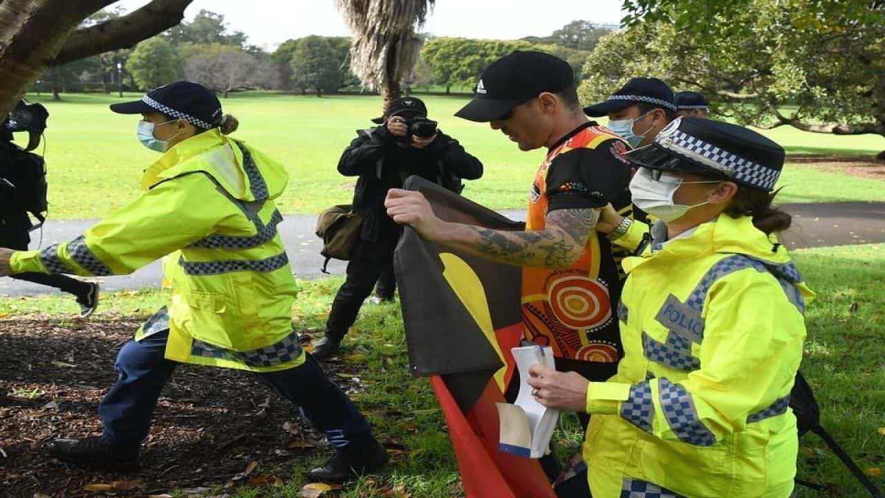 A man is detained by NSW Police during a Black Lives Matter