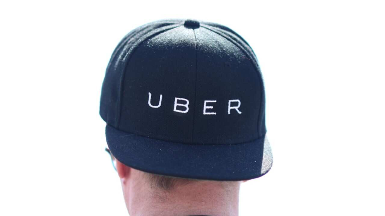 A man wearing an Uber cap