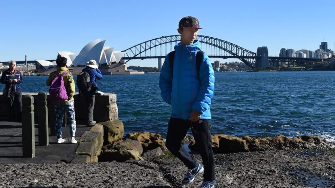 Chinese tourists take in the sites of the Sydney Harbour Bridge