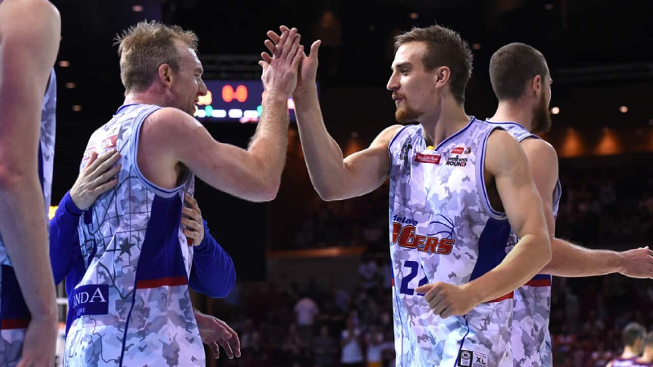 Adelaide 36ers players celebrate defeating the Brisbane Bullets