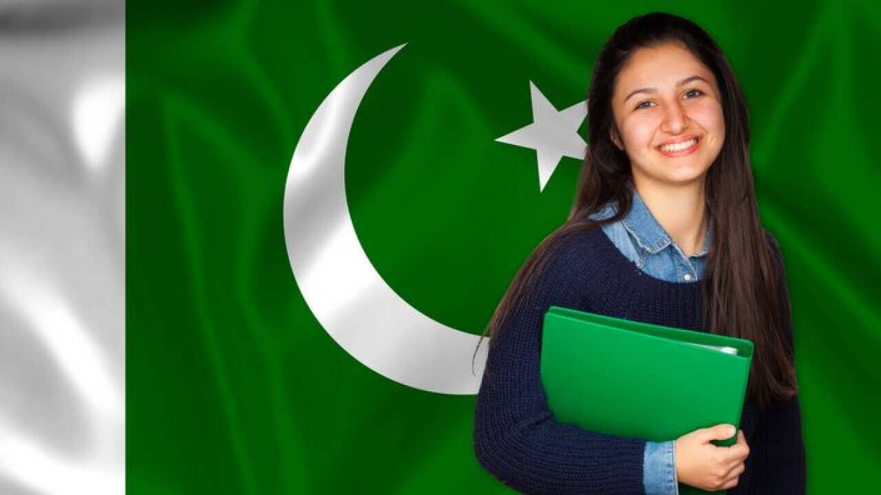 Teen student smiling over Pakistani flag