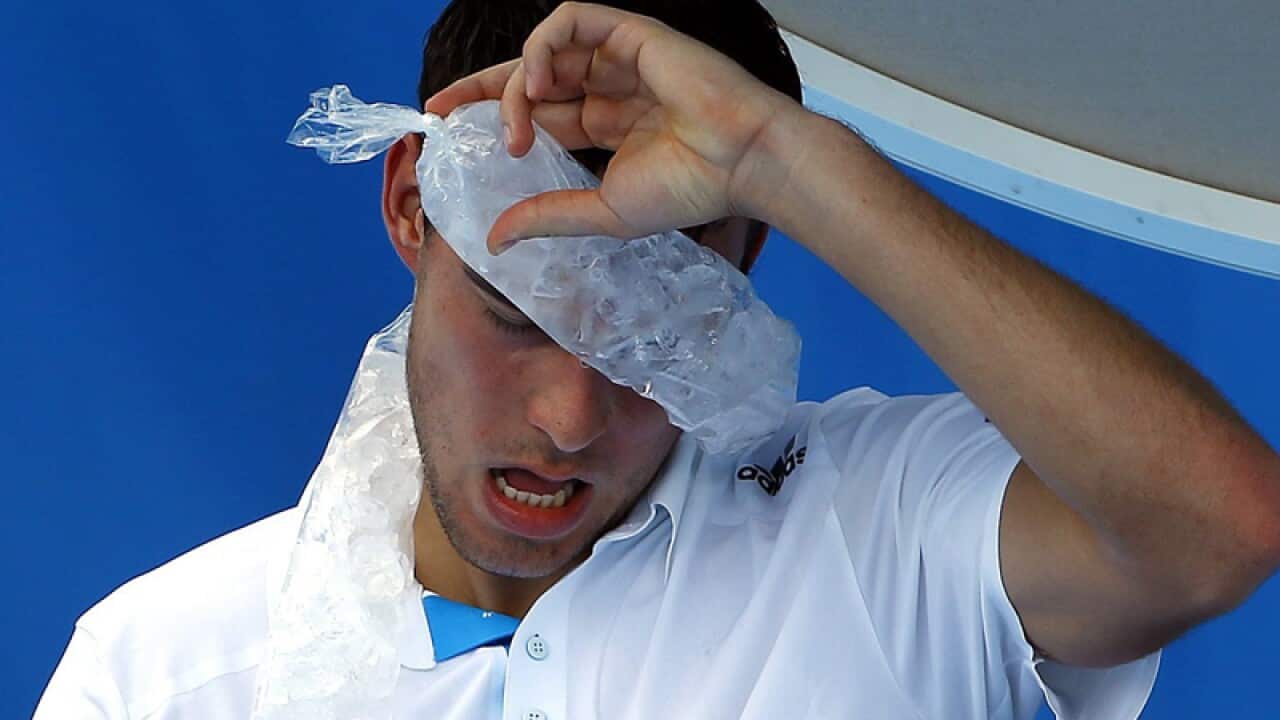 Polish tennis player Jerzy Janowicz uses an ice pack