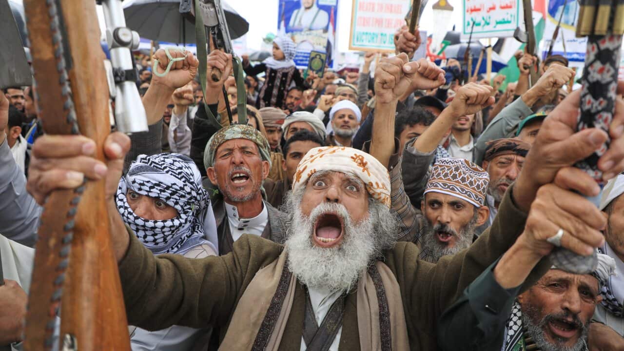 Houthi supporters shout slogans during a rally against Israel and the United States' war on Iran.