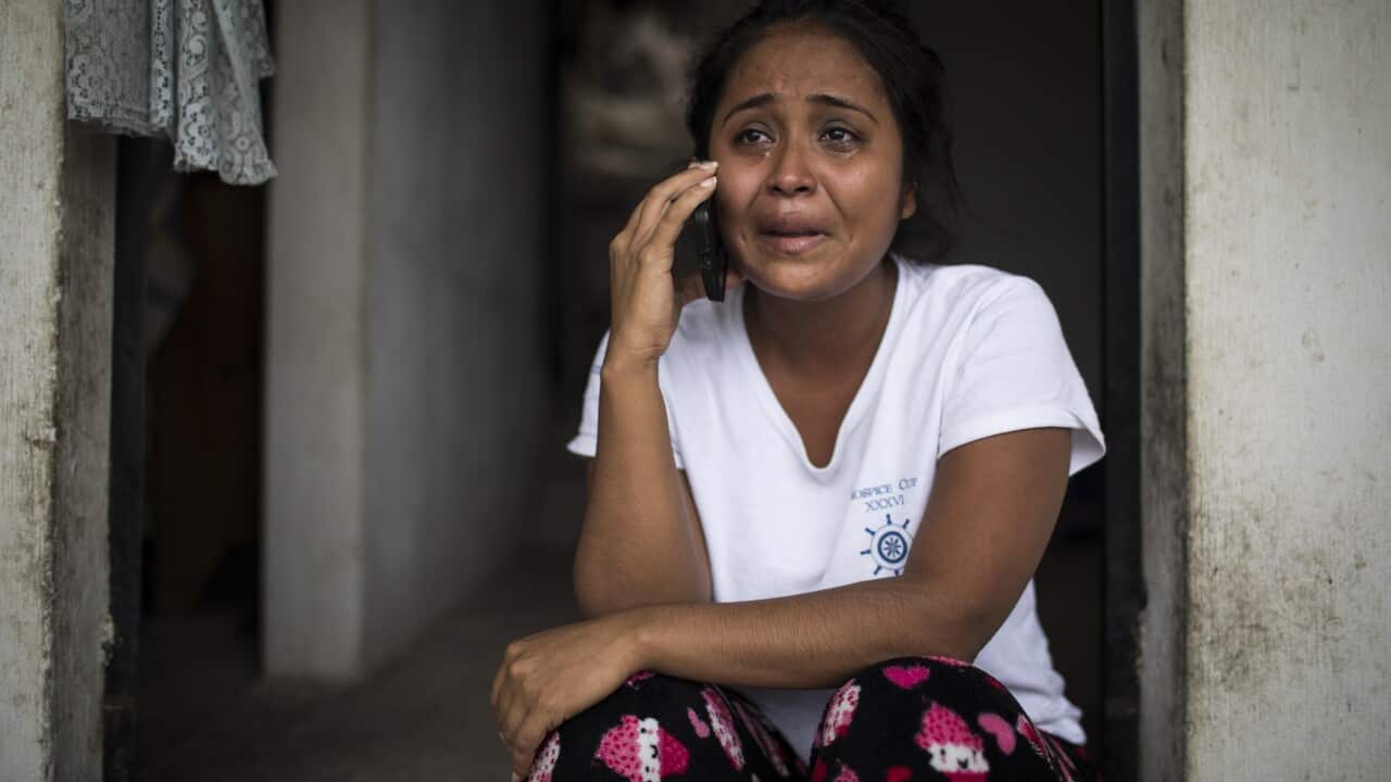 Elsa Johana Ortiz Enriquez, who was deported to Guatemala from the United States on June 5 without her son Anthony, 8, speaks to a social worker in San Mauricio, Guatemala.