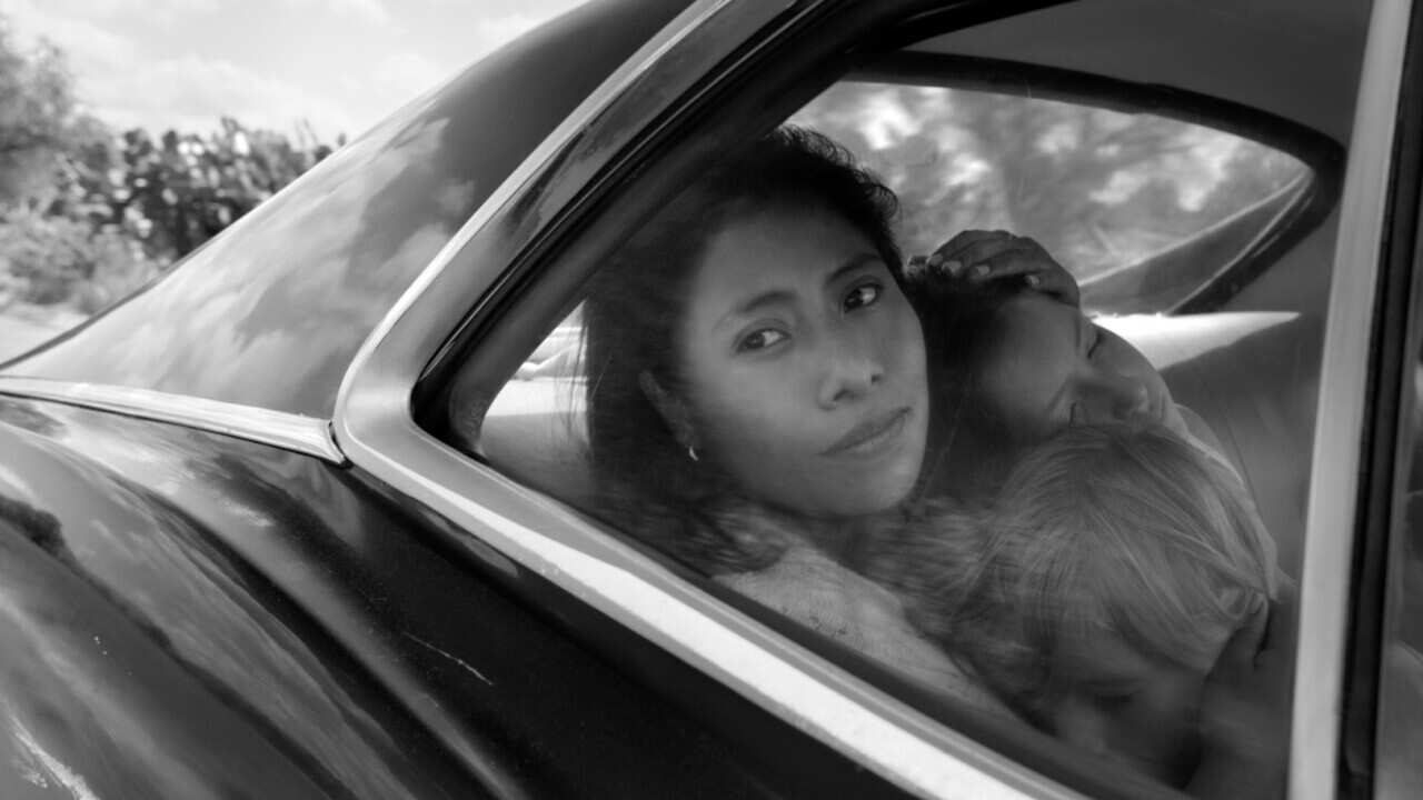 This image released by Netflix shows Yalitza Aparicio, center, in a scene from the film "Roma," by filmmaker Alfonso Cuaron.