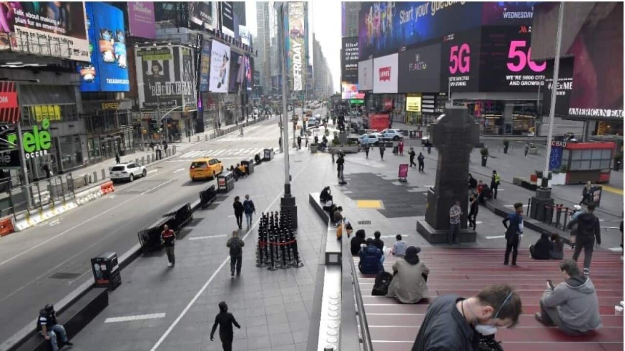 Almost no vehicle traffic and few pedestrians are seen in this Times Square photo, Thursday, March 20, 2020 in New York.