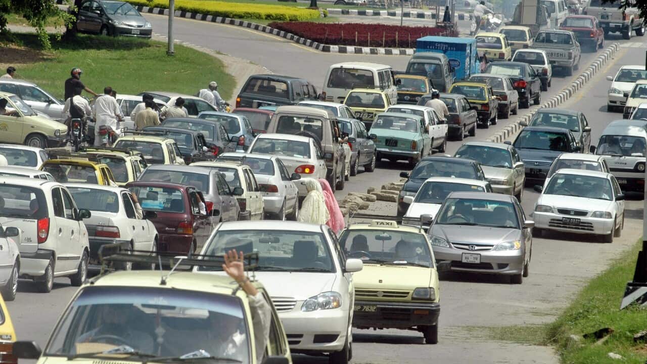 Pakistani commuters sit in their vehicle