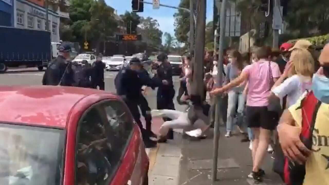Police throw a student protester to the ground in Camperdown.