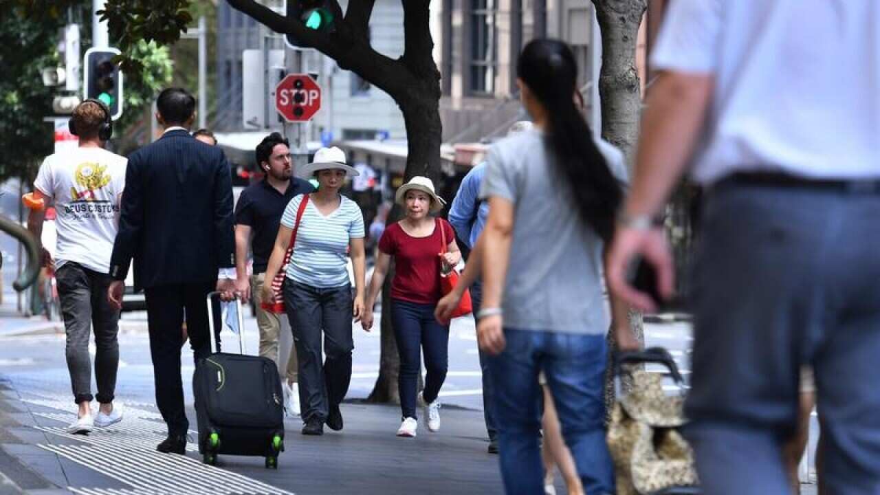 People walk on a Sydney street.