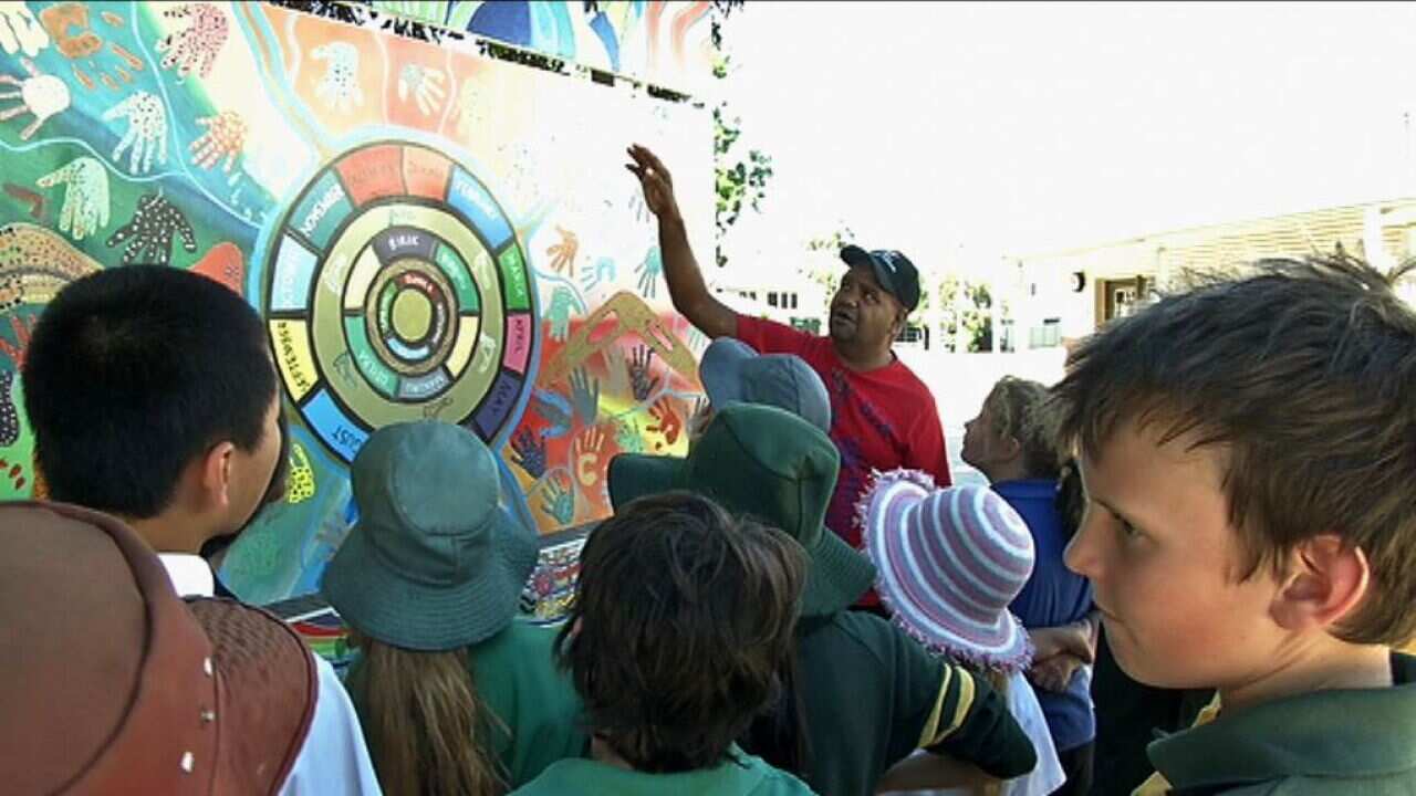 Noongar artist Peter Farmer and the six seasons mural painted by the children at Coolbinia Primary School-1.jpg