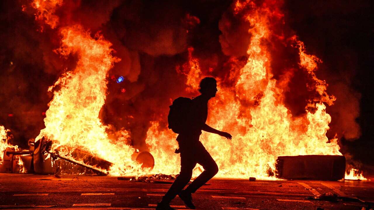 Fires burn following an evening of rioting in Barcelona, Spain.