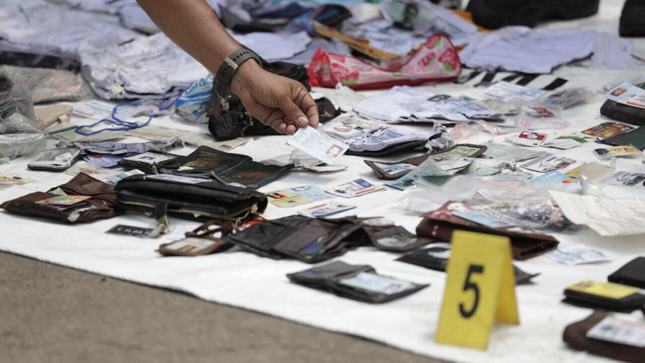 Indonesian rescuers collect and classify wreckage pieces and passenger belongings from the plane crash at Tanjung Priok Harbour, Jakarta, Indonesia.