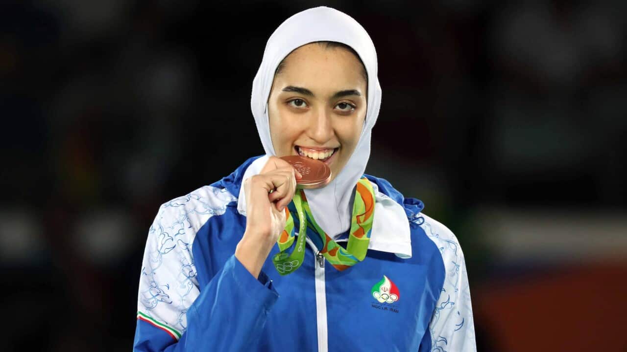 Kimia Alizadeh poses on the podium for the women's 57kg competition of the Rio 2016 Olympic Games.