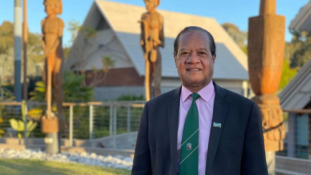 Robert Sisilo stands outside the Solomon Islands High Commission in Canberra.