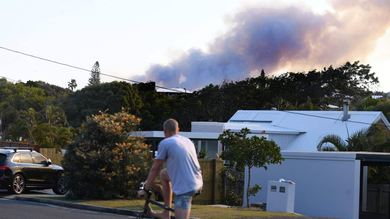 Dark smoke billows from a bushfire near Peregian Beach on the Sunshine Coast.