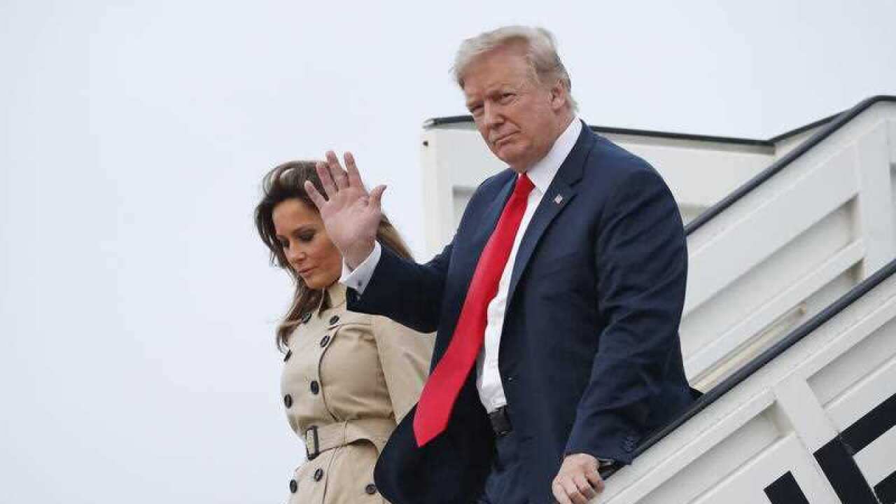 President Donald Trump and Melania Trump walks down the stairs during their arrival on Air Force One at Melsbroek Air Base, Tuesday, July 10, 2018, in Brussels, Belgium.