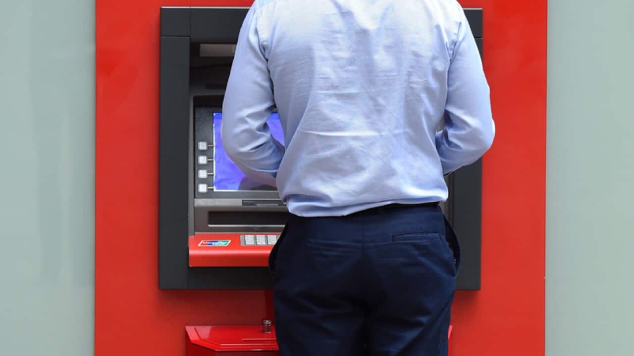 A man uses an ATM